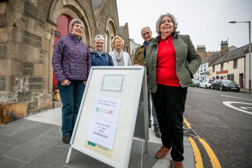 photo shows a group of volunteers standing outside St James Church, in Broughty Ferry.