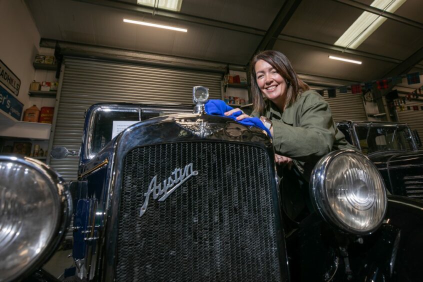 SVVC administrator Lesley Munro shines up the 1930s Austin which is part of the auction in Glamis