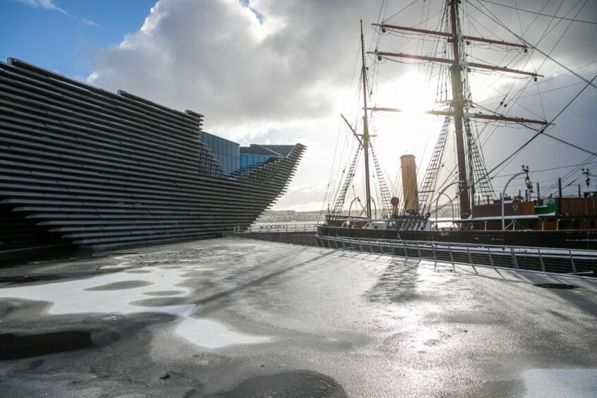 photo shows the V&A Dundee and RRS Discovery bathed in low sunlight on a winter day.