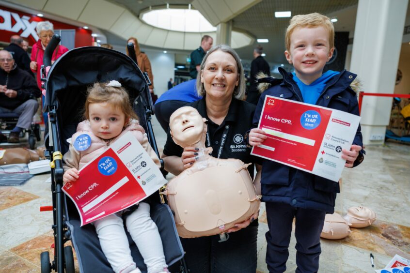 Two of the youngest who attended Poppy, 2, and Harris Christison, 4, who received their certificates from Karen McDonald (St John's Scotland Deputy Lead CPR Champion). I