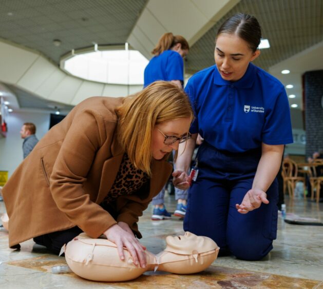 Cara is put through the CPR training by third year nursing student Karen Ford
