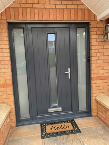 A new front door by Meraki with black paint and welcome mat.