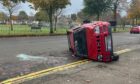 One car ended on its side following the crash on Provost Scott's Road. Image: Campbell Finlayson