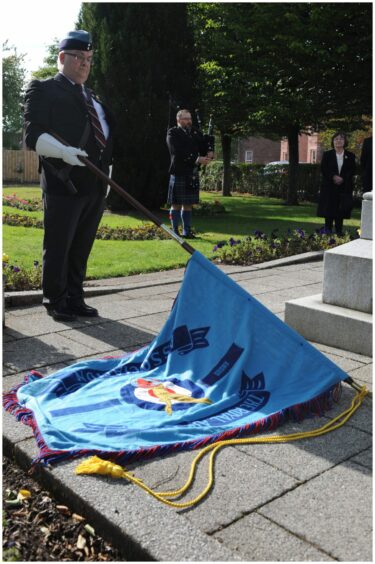 The RAFA standard is lowered at the Edzell service.