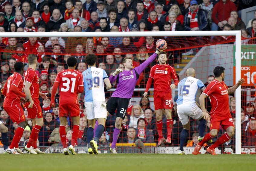 Liverpool goalkeeper Simon Mignolet denies Blackburn defender Alex Baptiste (No 15)