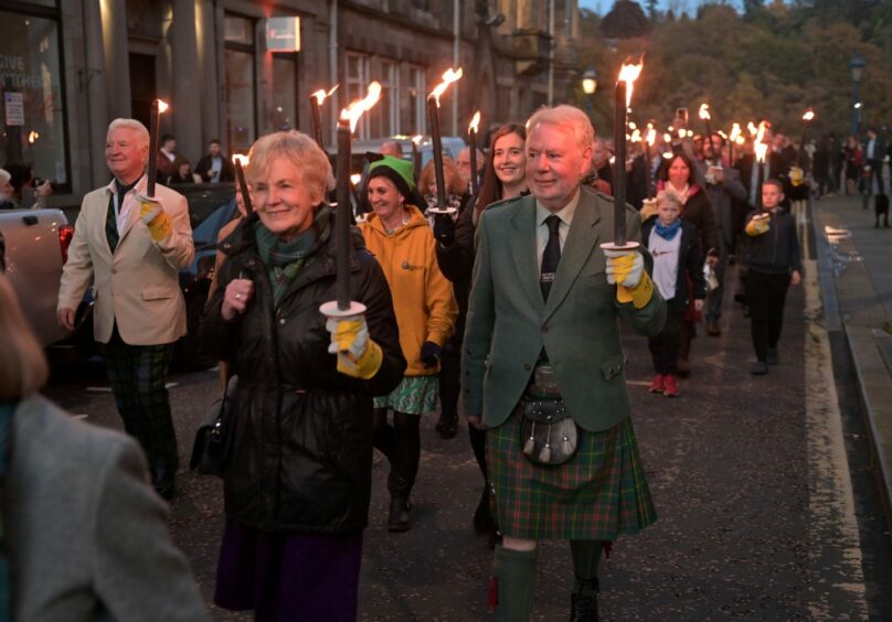 photo shows torch light procession through the streets of Perth for the opening concert of the 2022 Royal National Mod