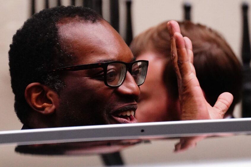 Photo shows Kwasi Kwarteng waving as he leaves 11 Downing Street.