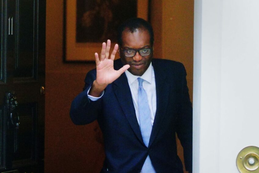 Photo shows Kwasi Kwarteng waving as he leaves 11 Downing Street.