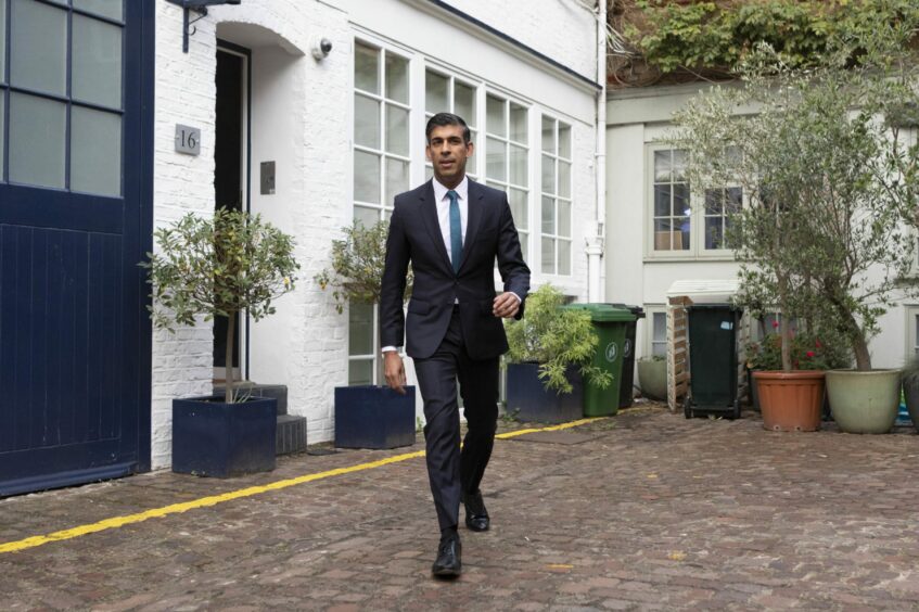 Photo shows Rishi Sunak leaving his home.