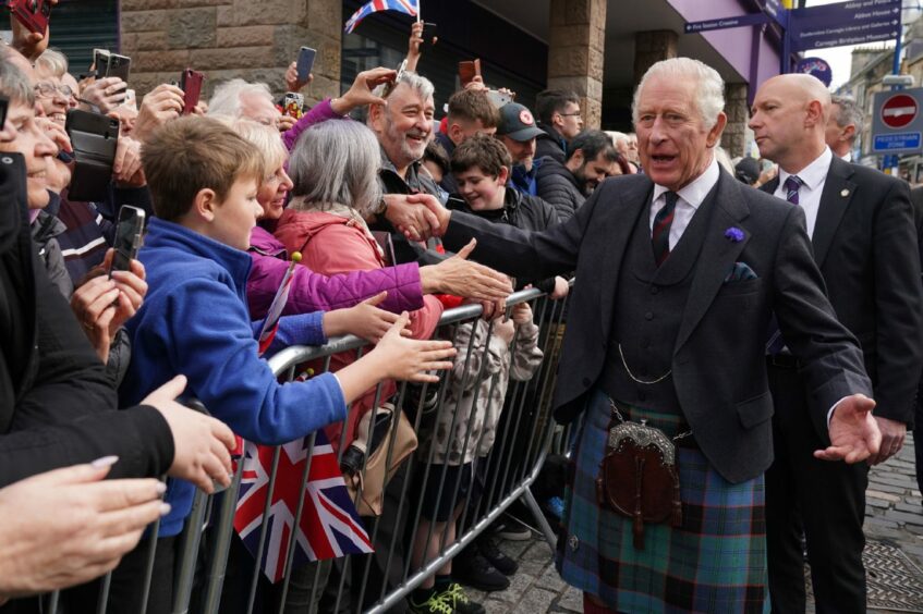 King Charles in kilt speaking to well wishers in Dunfermline.