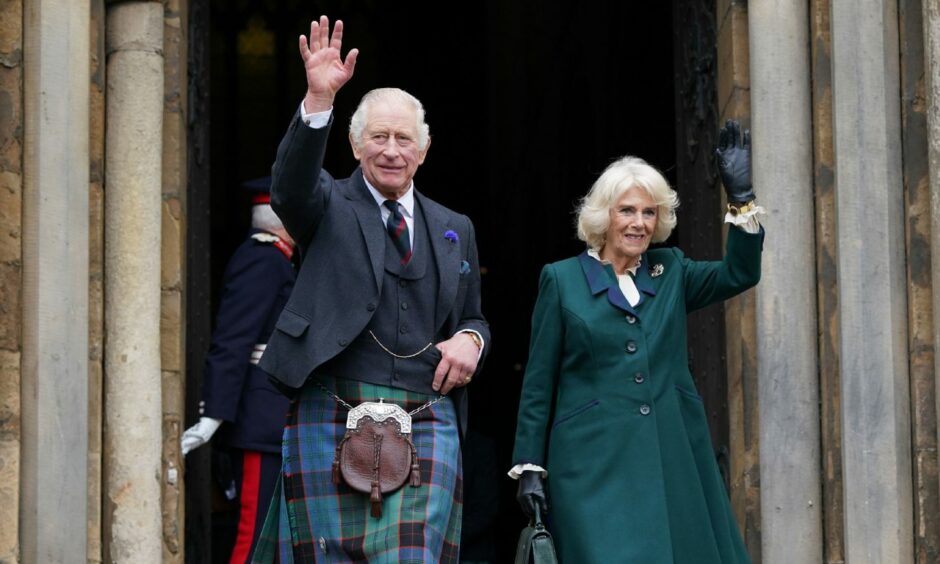 King Charles III and Queen Consort Camilla wave to the crowd in Dunfermline. 