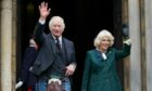 King Charles III and Queen Consort Camilla waving to the crowd in Dunfermline in early October.