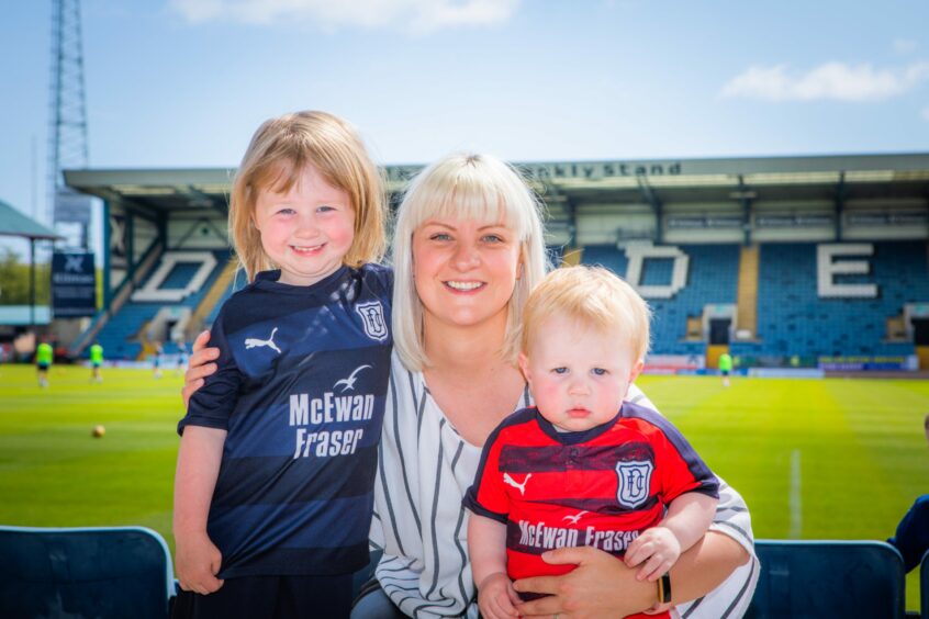 photo shows Dundee FC fan Lynette Bryceland with children Lois and Patrick, in Dundee FC kits, at Dens Park in 2019
