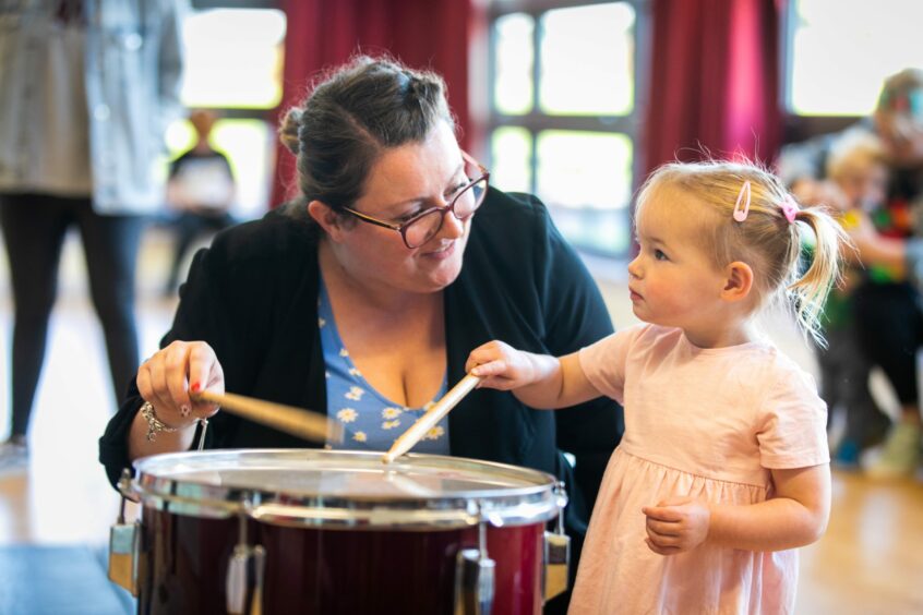 Scarlett Gerard, 2, with mum Laura making some noise on the drum.