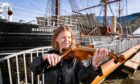 Georgia Shackleton playing the violin at RRS Discovery. Image: Steven Brown/DC Thomson.
