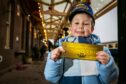 An excited young Polar Express passenger with his golden ticket in 2021. Image: Steve Brown/DCThomson