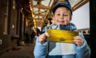 An excited young Polar Express passenger with his golden ticket in 2021. Image: Steve Brown/DCThomson
