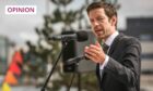 Photo shows Dundee City Council leader John Alexander speaking into a microphone at a public event.