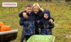 Photo shows the writer Lynne Hoggan and her two boys in the middle of a pumpkin patch.
