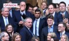 photo shows new Prime Minister Rishi Sunak with well-wishers outside Conservative Campaign HQ.