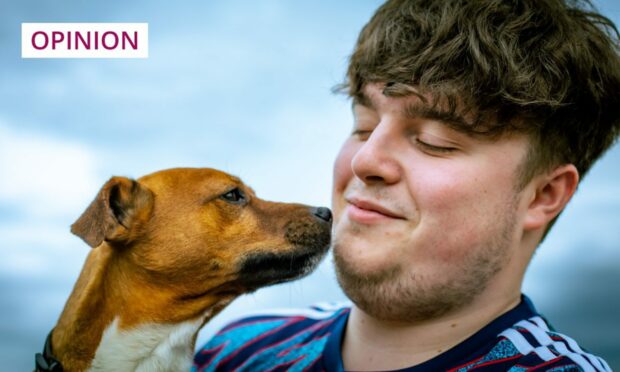 Photo shows Ally McLaren with a brown jack russell terrier.