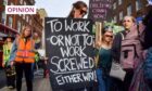 photo shows a protester with a placard which reads 'To work or not to work? Screwed either way'.