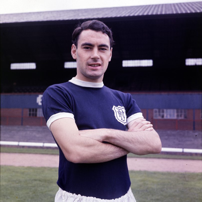 Alan Gilzean poses for a picture with his arms folded in his Dundee FC kit at the stadium in 1962.
