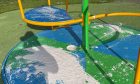 Vandals have covered play equipment in paint.