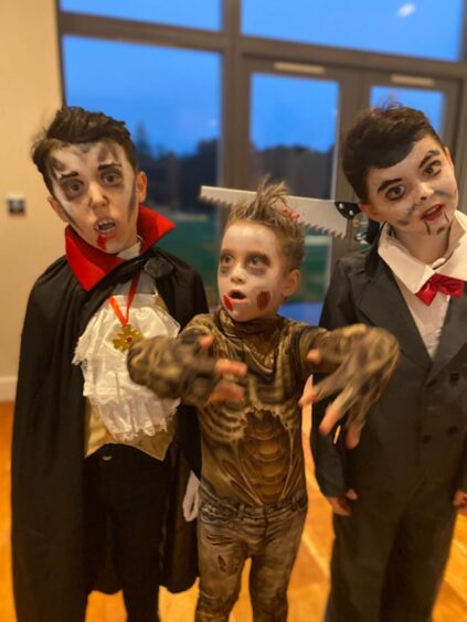 Photo shows Martel Maxwell's three sons in fancy dress for Halloween.