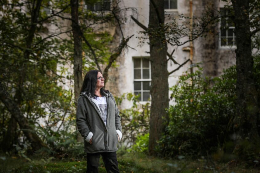 photo shows a woman, Elaine McLaughlin, standing outside Fornethy House as it looks today.