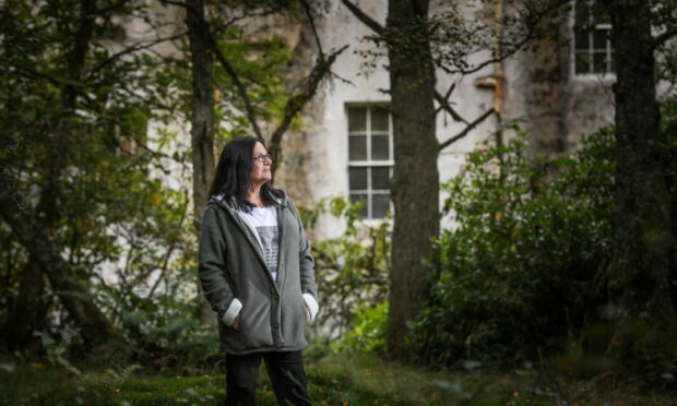 A woman standing in the woods near the former Fornethy House Residential School in Angus