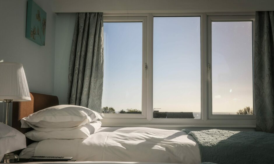 Inside a room at the Honeypot in Crail looking out the window at a blue sky.