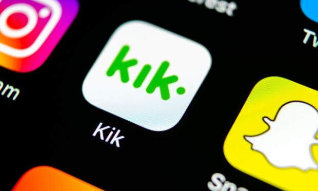 Kik Messenger app logo on phone