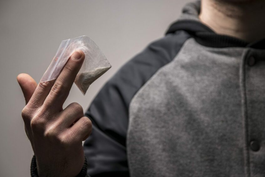 Man holding bag of drugs 