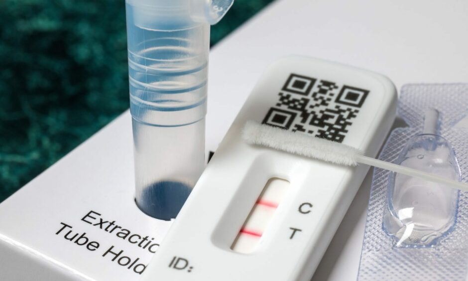 Lateral flow test kit showing a positive test result