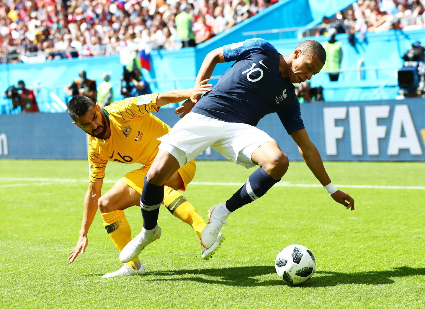 Aziz Behich in action for Australia against Kylian Mbappe of France at the 2018 World Cup in Russia. Image: Shutterstock.