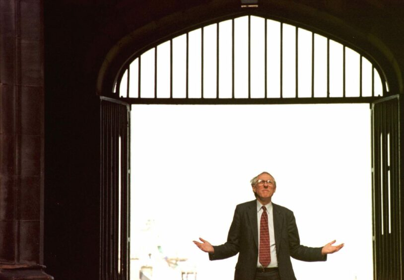 photo shows Donald Dewar, standing at the entrance to the General Assembly Hall in Edinburgh.
