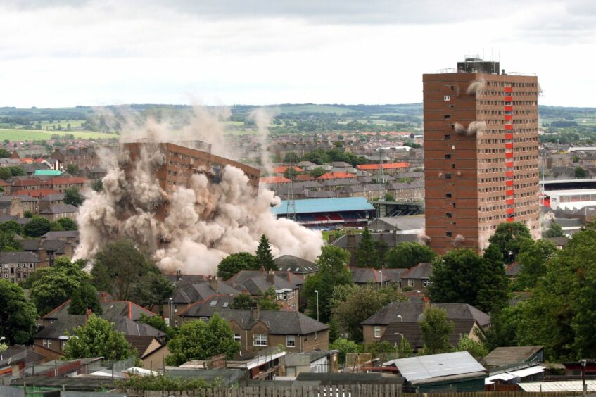 photo shows Derby Street multi-storey blocks being demolished in a controlled explosion.