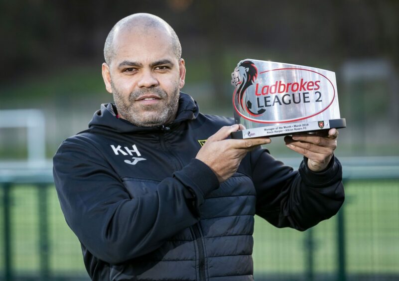 Harper with a manager of the month award from a previous stint at Cliftonhill. 