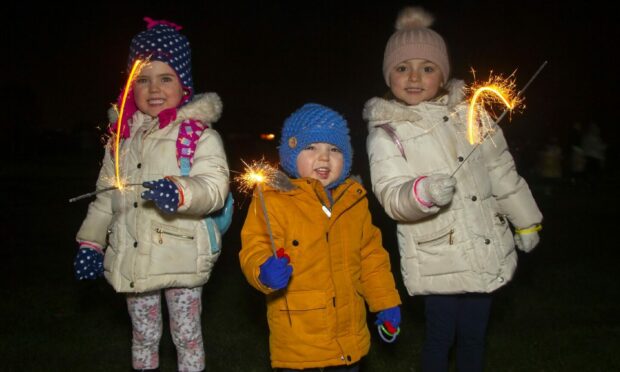 Ava Burgess, her brother Kai and sister Mia enjoy the fun at Lochee Park in 2018. Image: DC Thomson.