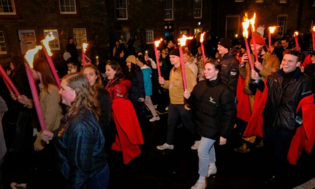 A torchlit parade makes its way through St Andrews as the Fife town celebrates the Big Hoooie. Image: Paul Reid
