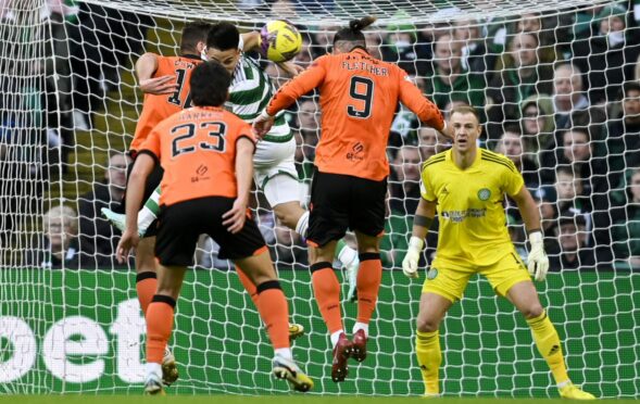 Dundee United star Fletcher's header strikes Celtic's Alexandro Bernabei  on the arm at Celtic Park. Image: Rob Casey/SNS Group
