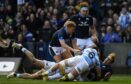 Duhan Van Der Merwe battles to score his try during Scotland's 52-29 win over Argentina.