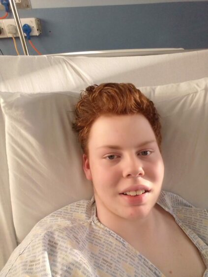 Photo shows Andrew Batchelor in a hospital bed.