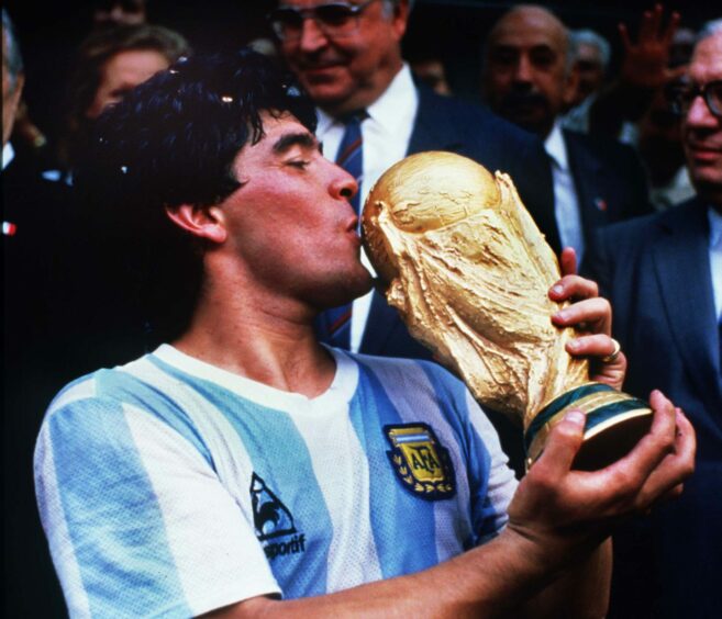 photo shows Diego Maradona kissing the World Cup trophy following the 1986 final.