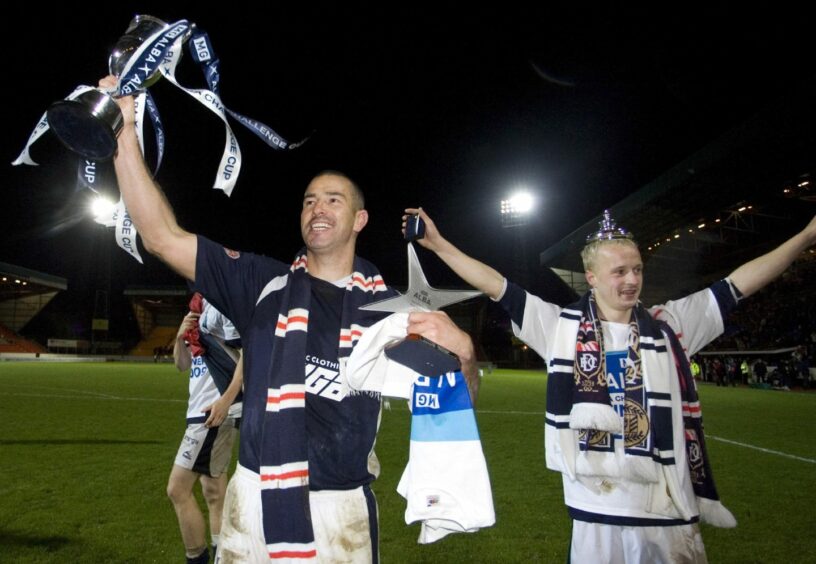 Dundee's James Lauchlan (left) holds the Alba Challenge Cup along with Leigh Griffiths (right).