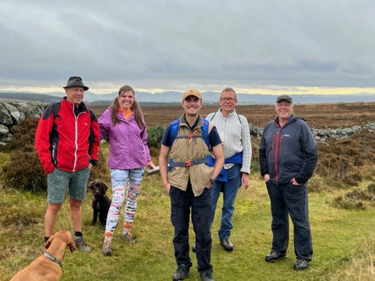 Andrew, centre, on a practice walk with friends Roy Mitchell, Kirsty Johnston, Doug Slowman, Chris Dodd and Andrew's dogs Amber and Cocoa.