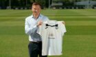 Andy Goldie, formerly of Dundee United, poses with a Swansea City jersey