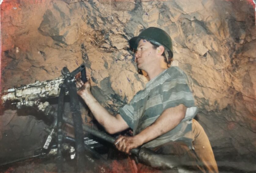 A photo of Brian working in a mine