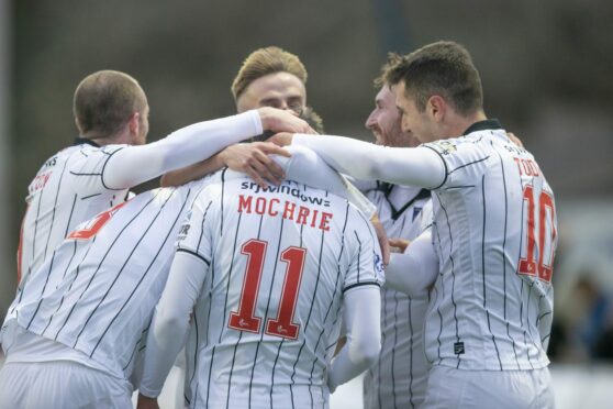 Chris Mochrie is congratulated by his Pars teammates.
